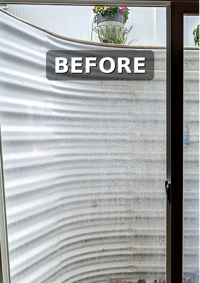 Window with heavy hard water stains before cleaning
