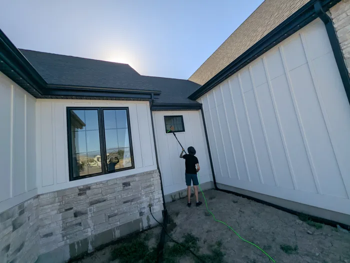 Bryan cleaning a window with his water fed pole and pure water hose